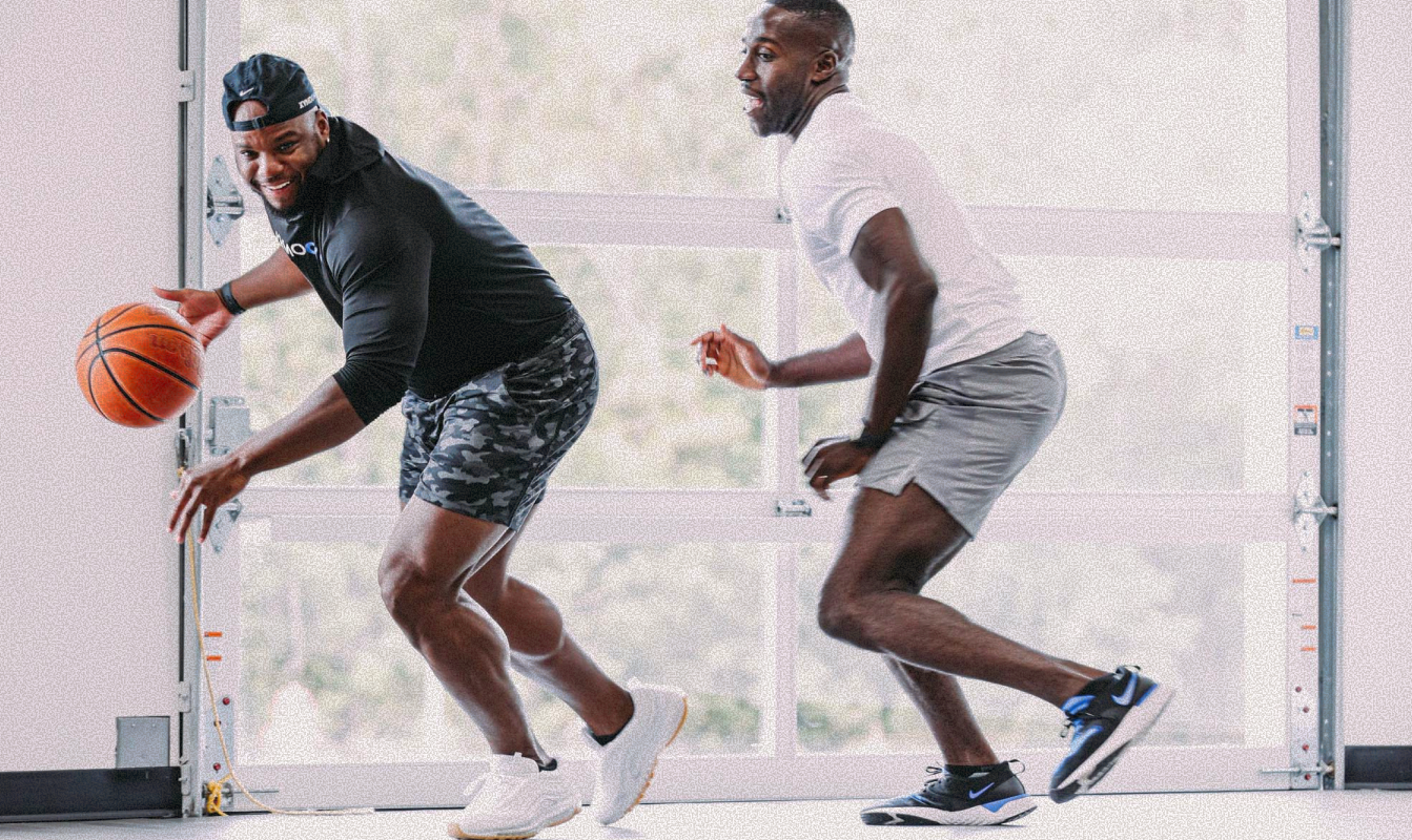 Two members playing basketball on the Soma House court