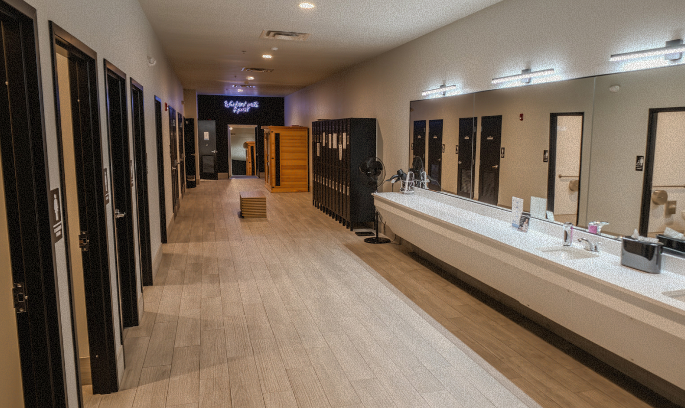 Soma House locker room hallway with lockers and private shower rooms